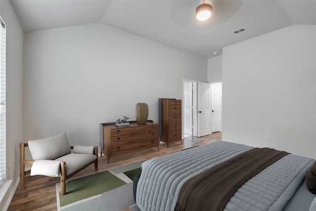 bedroom featuring hardwood / wood-style flooring and lofted ceiling