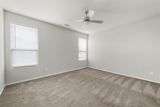 spare room with carpet flooring and ceiling fan