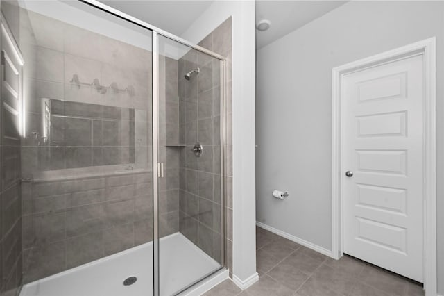 bathroom featuring tile patterned floors and a shower with shower door