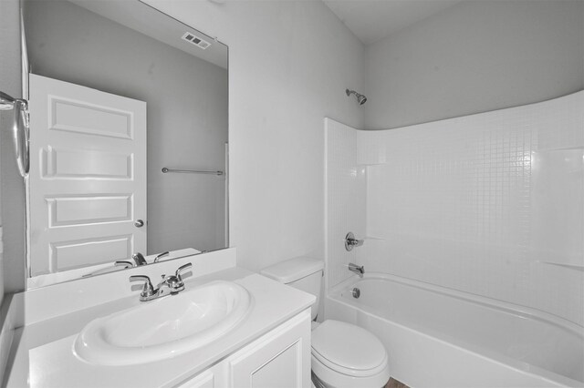 full bathroom featuring vanity, bathtub / shower combination, and toilet