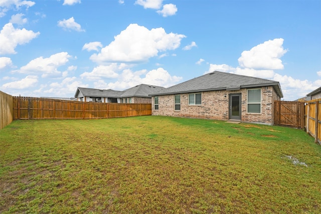 rear view of house with a yard