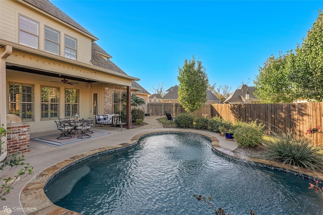 view of pool featuring a patio, a fenced backyard, a ceiling fan, and a fenced in pool