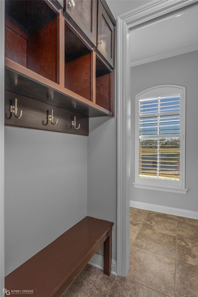 mudroom with baseboards and crown molding