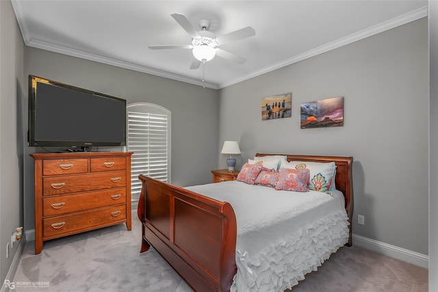 bedroom featuring light colored carpet, crown molding, baseboards, and ceiling fan