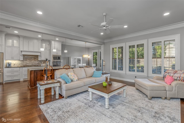 living room featuring crown molding, ceiling fan, and dark wood-type flooring