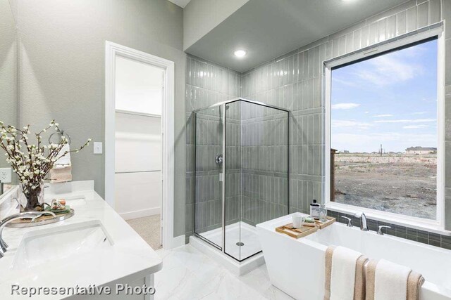 bathroom featuring vanity and separate shower and tub