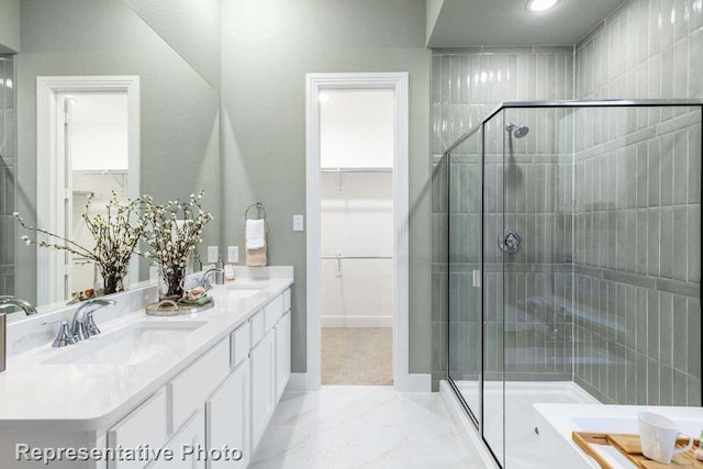 bathroom with a textured ceiling, vanity, and an enclosed shower