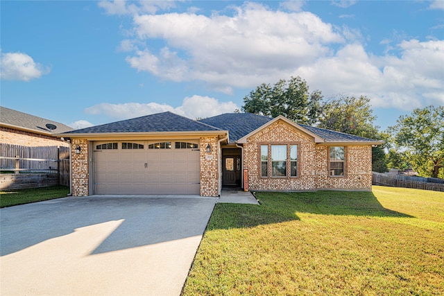 single story home featuring a garage and a front lawn