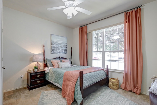 carpeted bedroom featuring multiple windows and ceiling fan