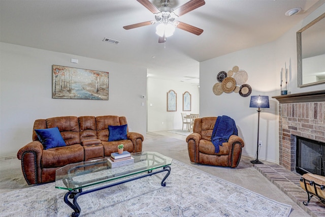 carpeted living room featuring ceiling fan and a fireplace