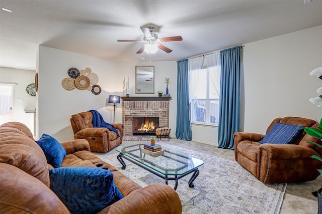 living room with light carpet, a fireplace, ceiling fan, and a textured ceiling