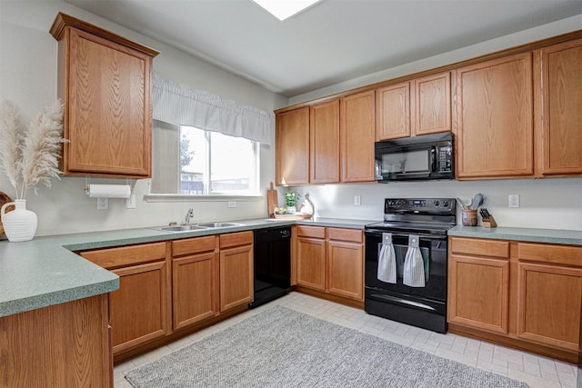 kitchen featuring black appliances, light tile patterned floors, and sink