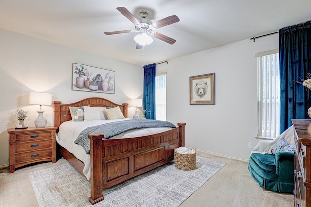 bedroom featuring ceiling fan and light carpet