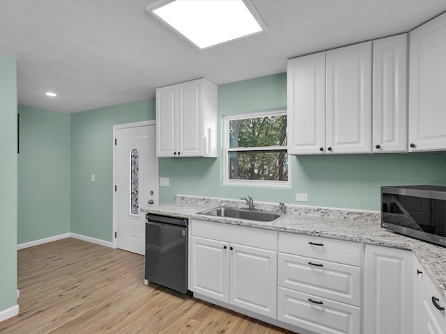 kitchen featuring sink, light hardwood / wood-style flooring, black dishwasher, light stone counters, and white cabinets