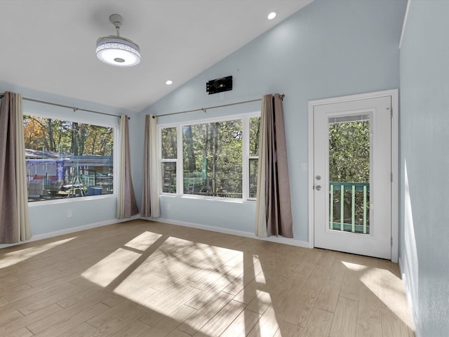 interior space featuring light wood-type flooring, baseboards, high vaulted ceiling, and recessed lighting