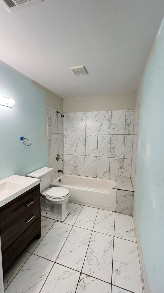 full bathroom featuring vanity, toilet, and tiled shower / bath