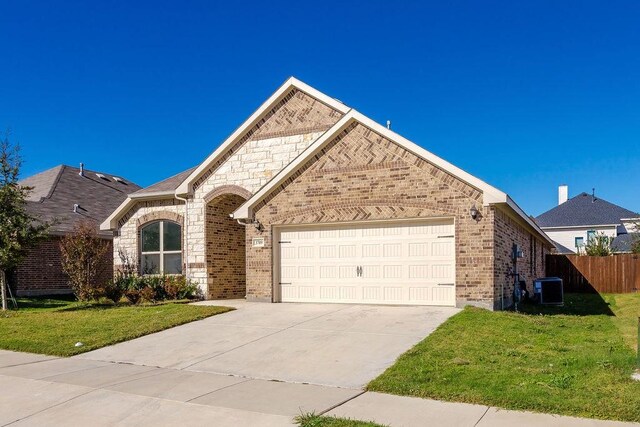 view of front of house with a garage, central air condition unit, and a front lawn