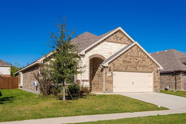 view of front of home featuring a front yard and a garage