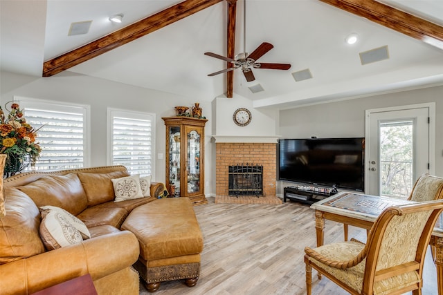 living room featuring lofted ceiling with beams, light hardwood / wood-style floors, and ceiling fan