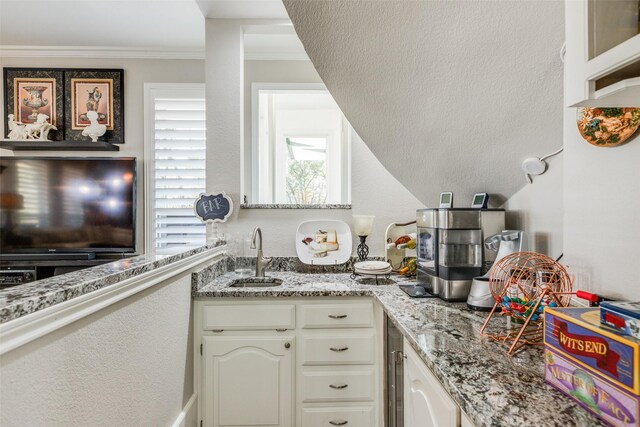 kitchen with light stone counters, hanging light fixtures, white cabinets, and stainless steel appliances