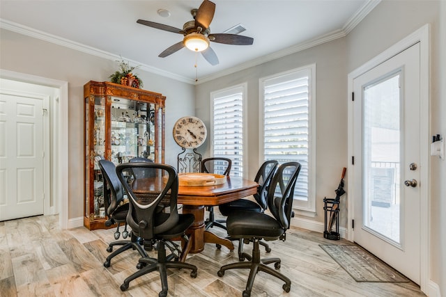 home office featuring light wood-type flooring, a wealth of natural light, and crown molding