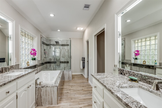 bathroom with wood-type flooring, vanity, and separate shower and tub