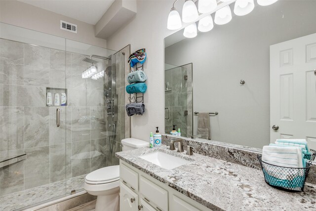 full bathroom with combined bath / shower with glass door, wood-type flooring, vanity, and toilet