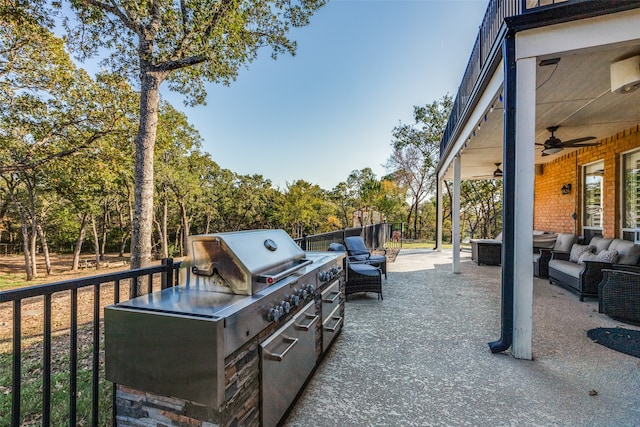 view of patio / terrace featuring an outdoor kitchen, ceiling fan, and an outdoor hangout area