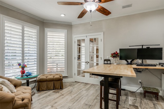 office with ceiling fan, french doors, ornamental molding, and light wood-type flooring