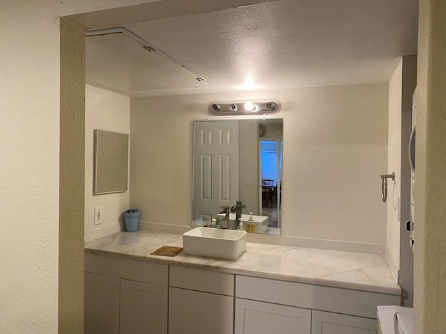 bathroom with vanity and a textured ceiling