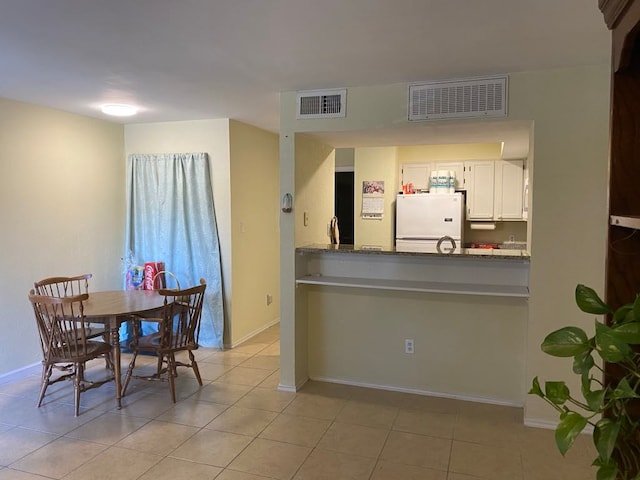 dining area with light tile patterned floors