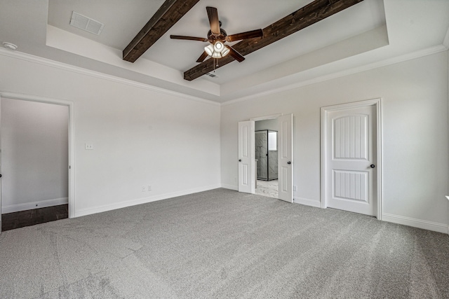 unfurnished room with a raised ceiling, ceiling fan, carpet floors, and ornamental molding