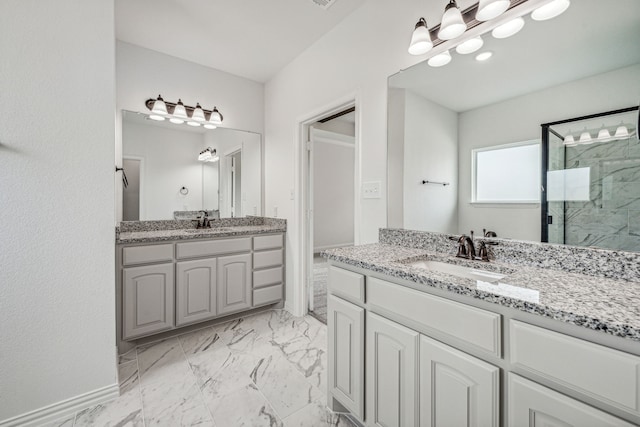 bathroom featuring a shower with door and vanity