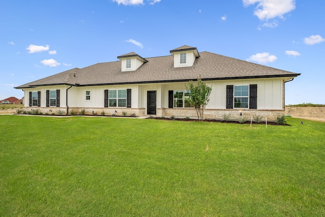 rear view of house featuring a lawn