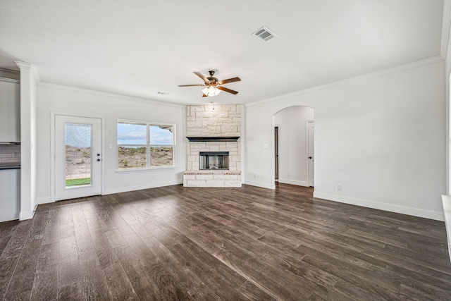 unfurnished living room with a fireplace, ceiling fan, dark hardwood / wood-style flooring, and crown molding