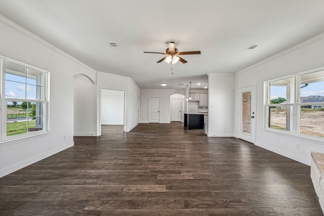 unfurnished living room featuring dark hardwood / wood-style floors, ceiling fan, and crown molding