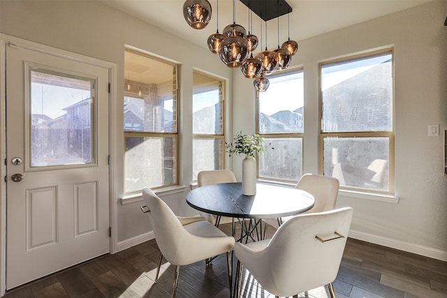 dining space with dark hardwood / wood-style floors, a mountain view, and an inviting chandelier