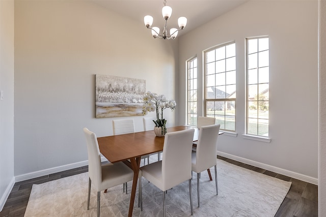 dining room featuring dark hardwood / wood-style flooring and an inviting chandelier