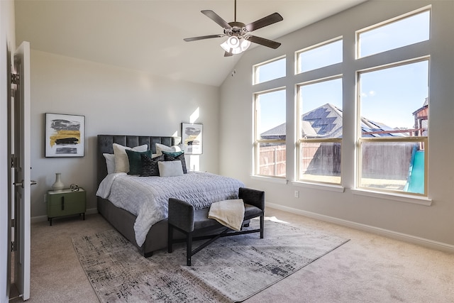 carpeted bedroom with vaulted ceiling, multiple windows, and ceiling fan