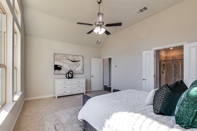 carpeted bedroom with ceiling fan and high vaulted ceiling