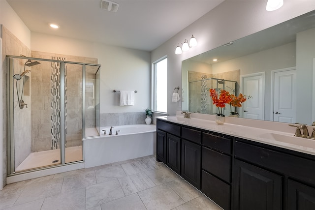 bathroom with vanity and independent shower and bath