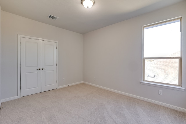 carpeted empty room with a wealth of natural light