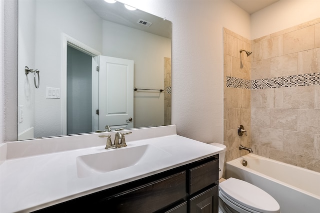 full bathroom with vanity, toilet, and tiled shower / bath combo