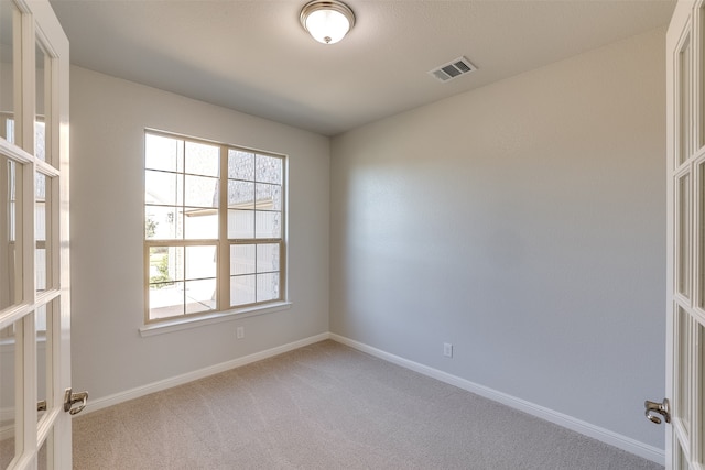 empty room featuring light carpet