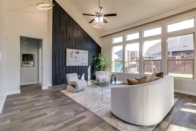 living room featuring ceiling fan, high vaulted ceiling, and wood-type flooring