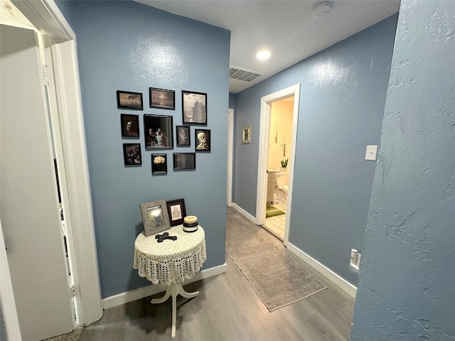 hall with hardwood / wood-style flooring