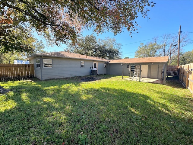 back of house with a patio area and a yard