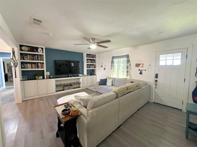 living room with hardwood / wood-style floors and ceiling fan