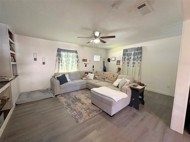 living room featuring ceiling fan and wood-type flooring