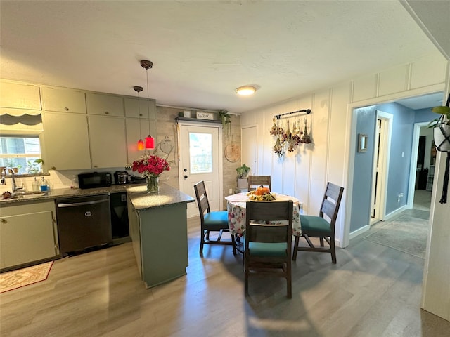 kitchen with dishwasher, hanging light fixtures, plenty of natural light, and light wood-type flooring